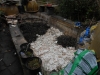 Bathroom debris being covered with pond filter stones